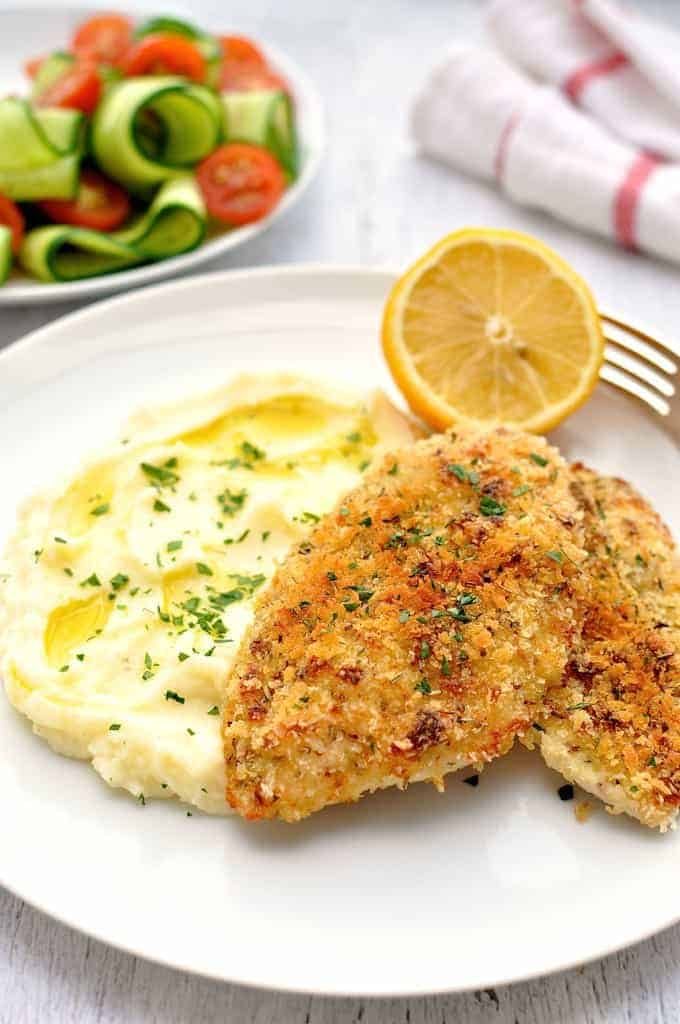 Super Quick Chicken Dinner of crunchy broiled / grilled chicken, mashed potato and side salad on a white plate, ready to be eaten.