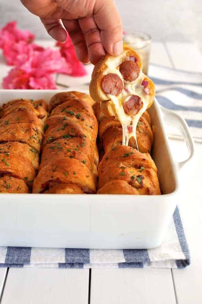Pulling a piece of Pull Apart Pizza Bread out