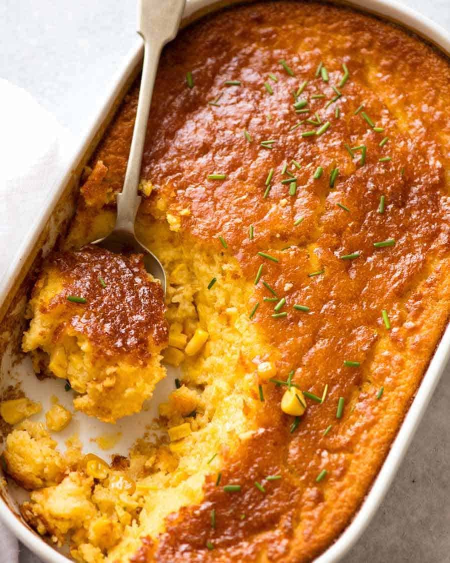 Overhead photo of Corn Casserole in a white dish, fresh out of the oven