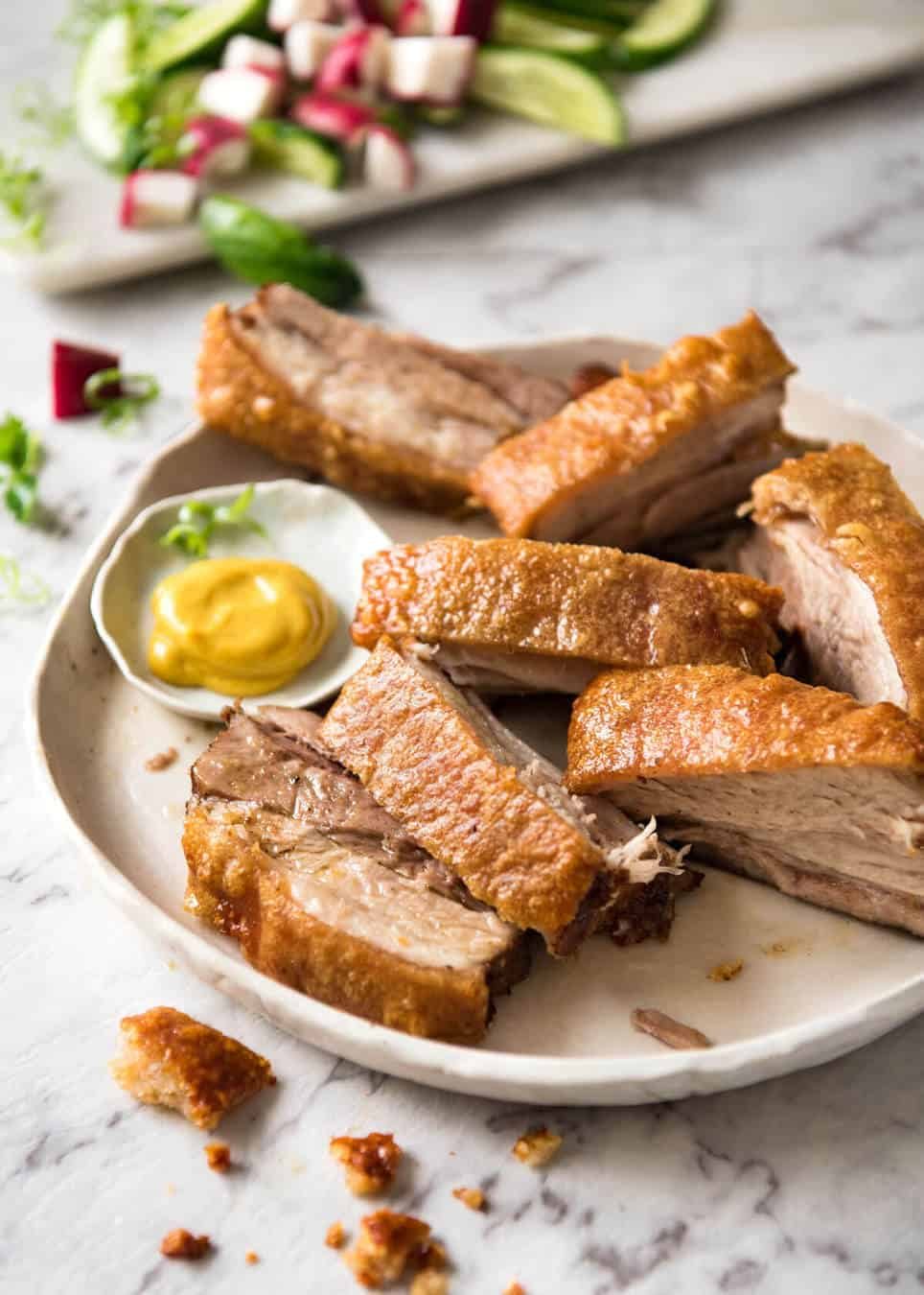 Chinese Crispy Pork belly slices on a plate, ready to be eaten