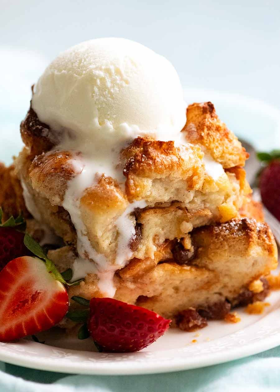 Bread and Butter Pudding in a bowl with ice cream, ready to be eaten