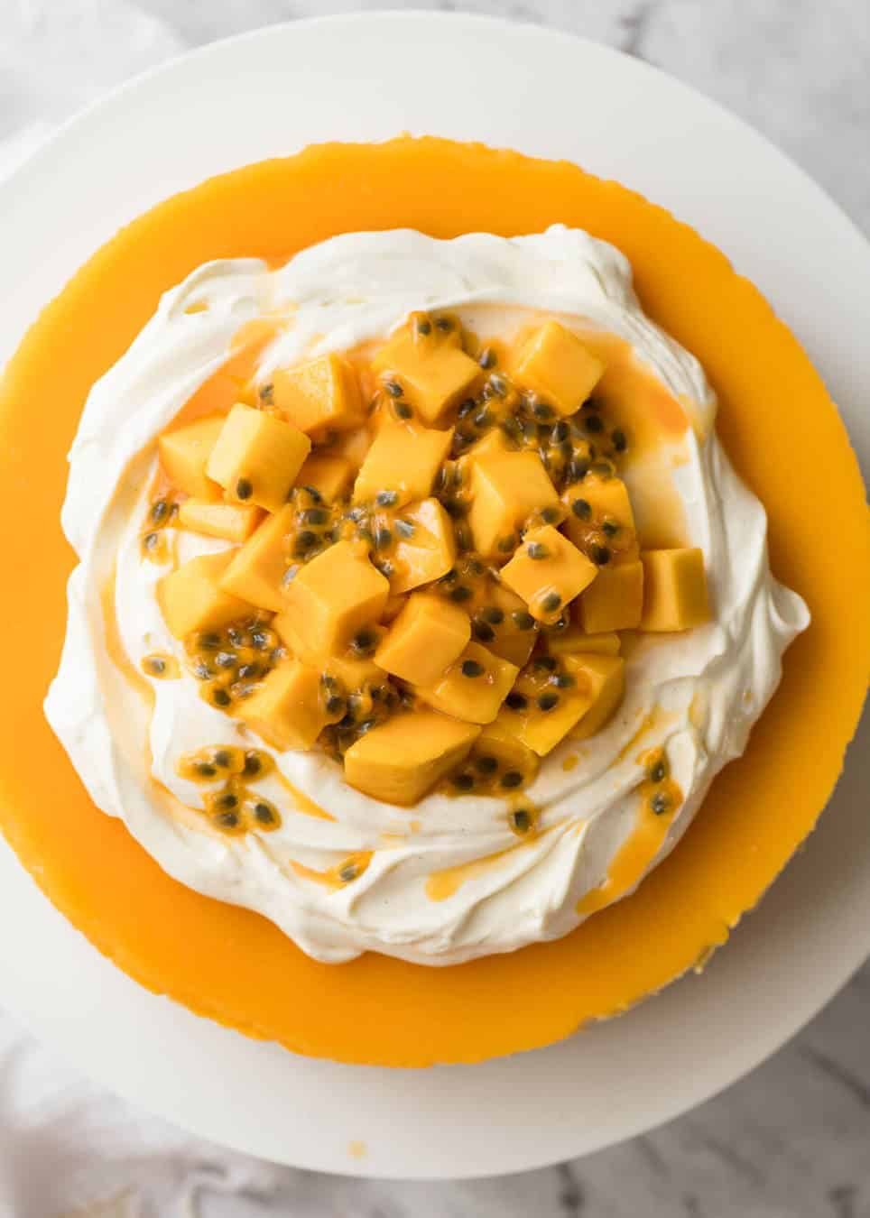 Toppings to decorate mango cheesecake - cream, passionfruit and mangoes. www.recipetineats.com