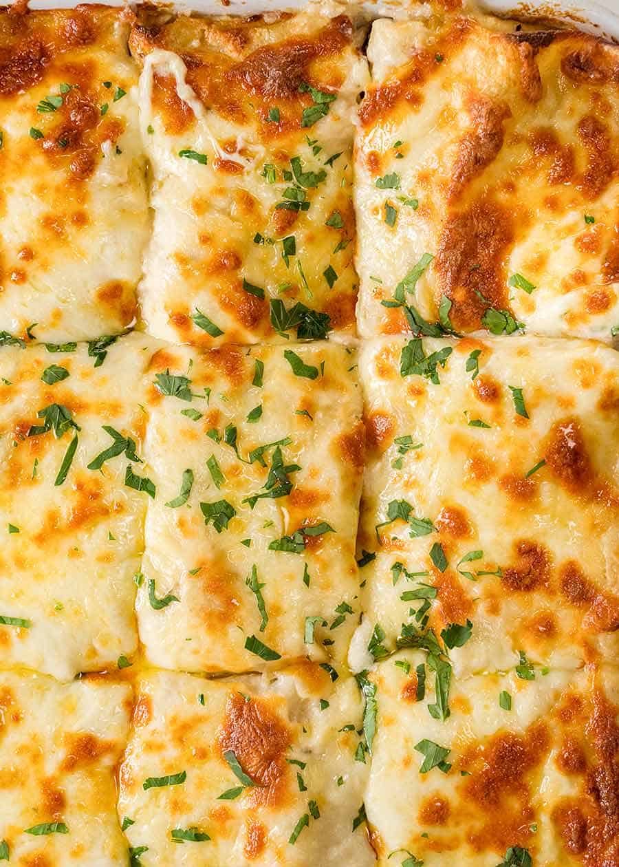 Overhead of Chicken Lasagna in a white baking dish, fresh out of the oven